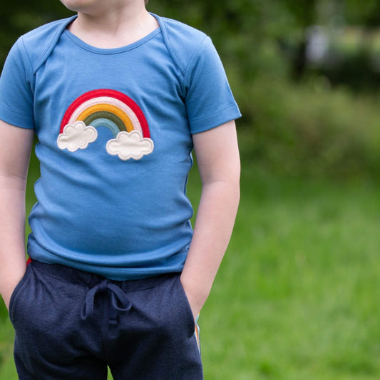 Boy wearing Little green Radicals Organic Short-sleeved t-shirt- blue rainbow appliqué