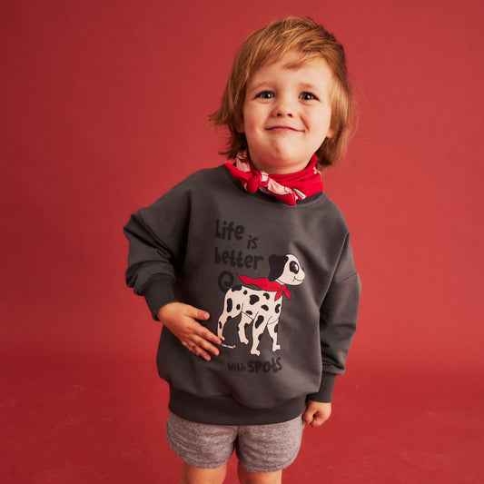 Boy wearing Dear Sophie organic Sporty shorts- dalmatian gray