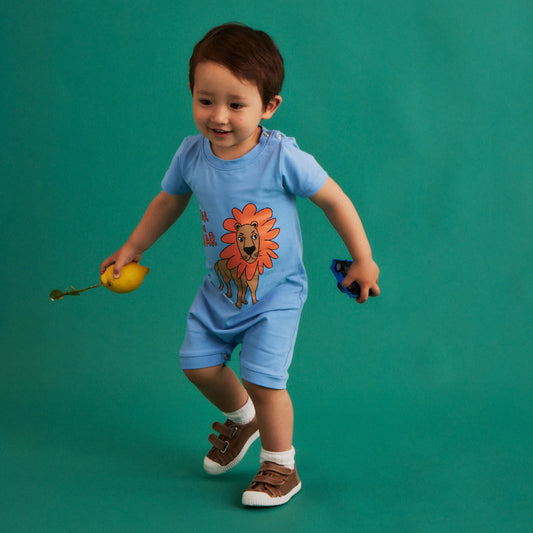 Baby wearing Dear Sophie organic Short romper- lion blue