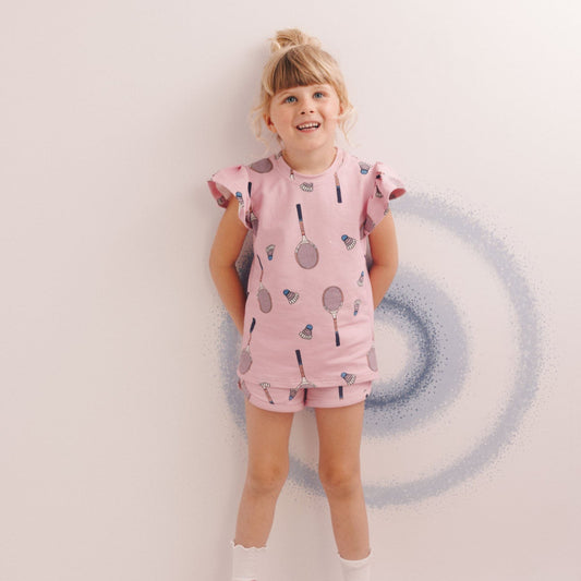 Girl wearing Dear Sophie organic Frill tank- racquet pink