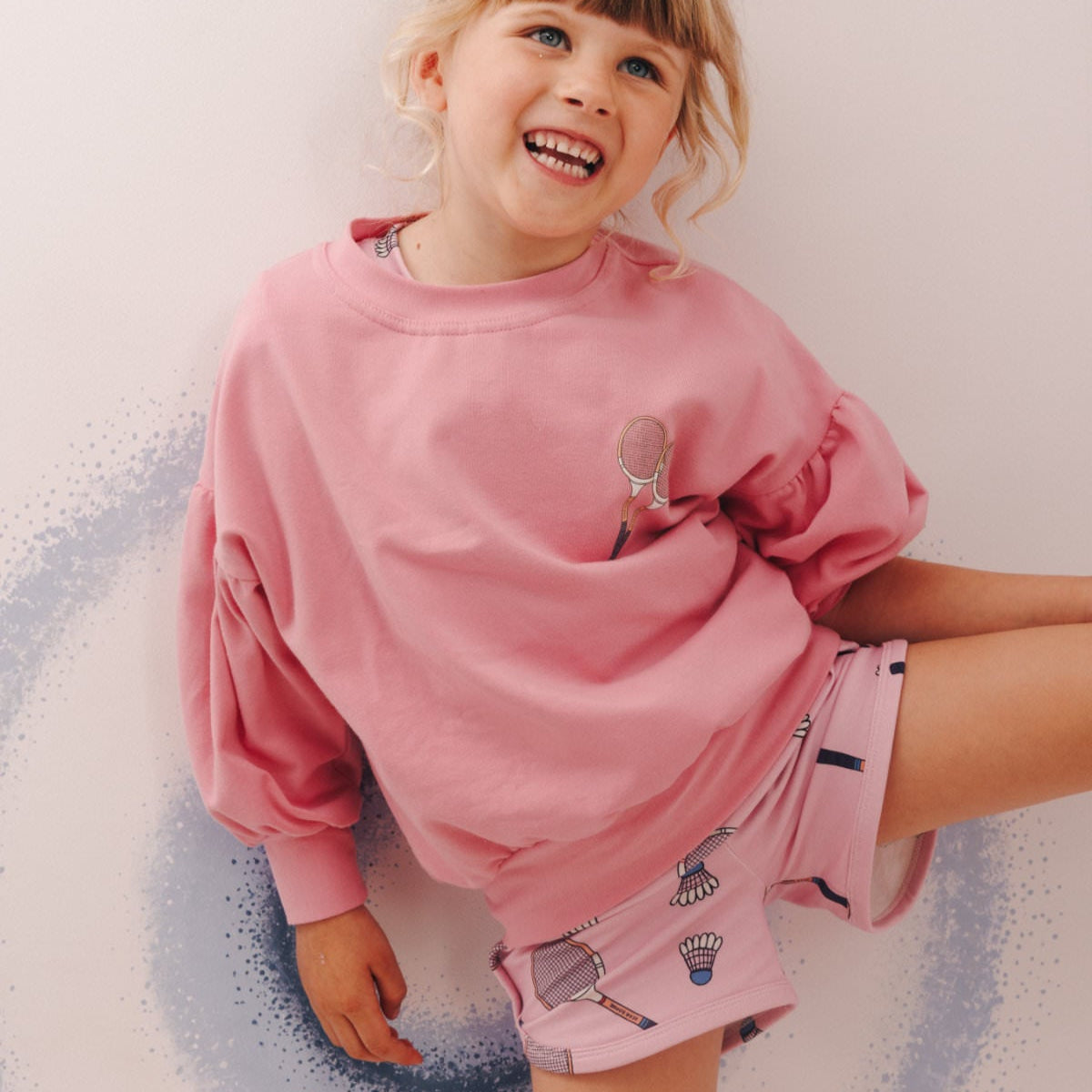 Girl wearing Sporty shorts- racquet pink