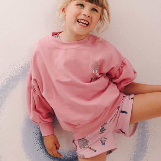 Girl wearing Sporty shorts- racquet pink