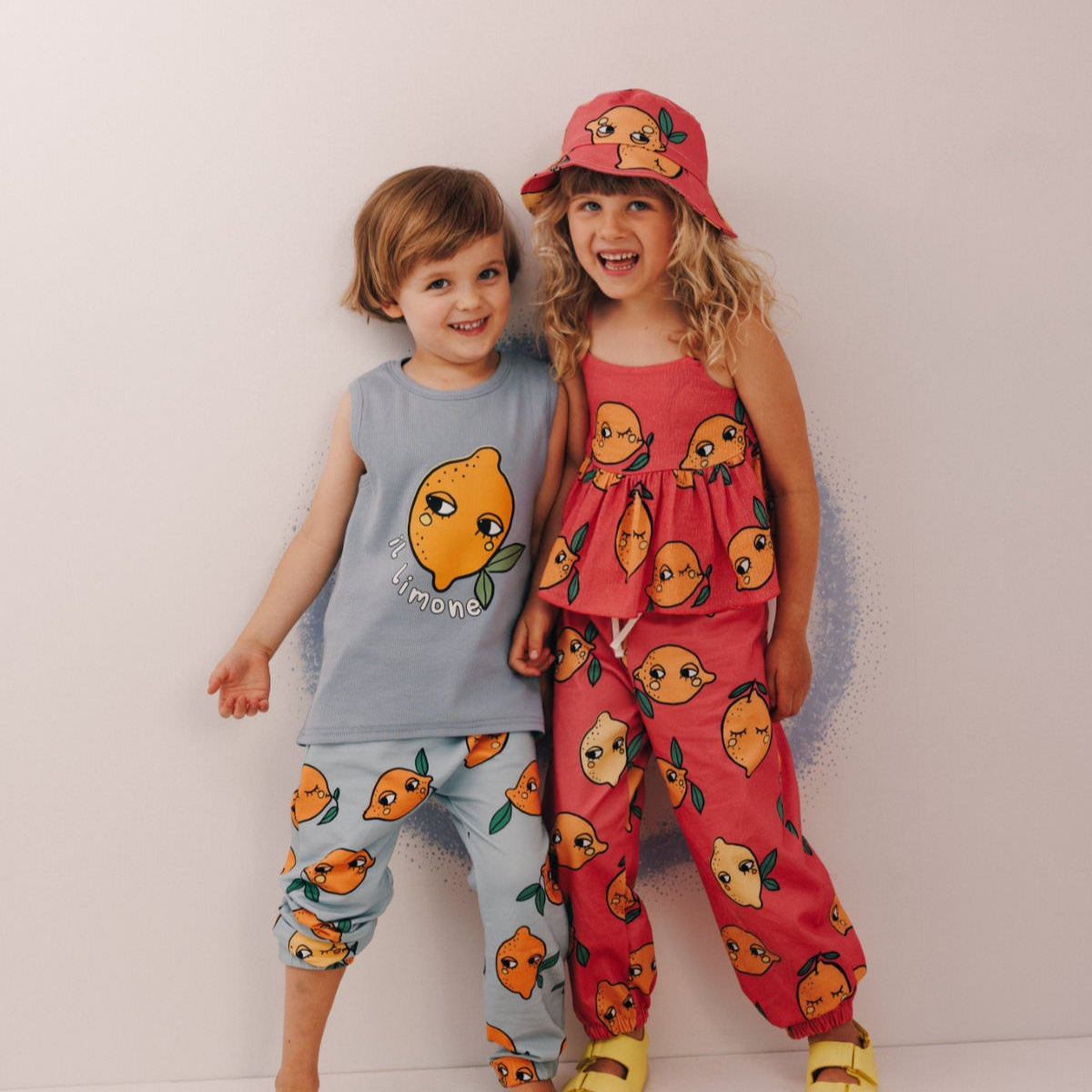 Girl wearing Dear Sophie organic Peplum tank top- lemon pink