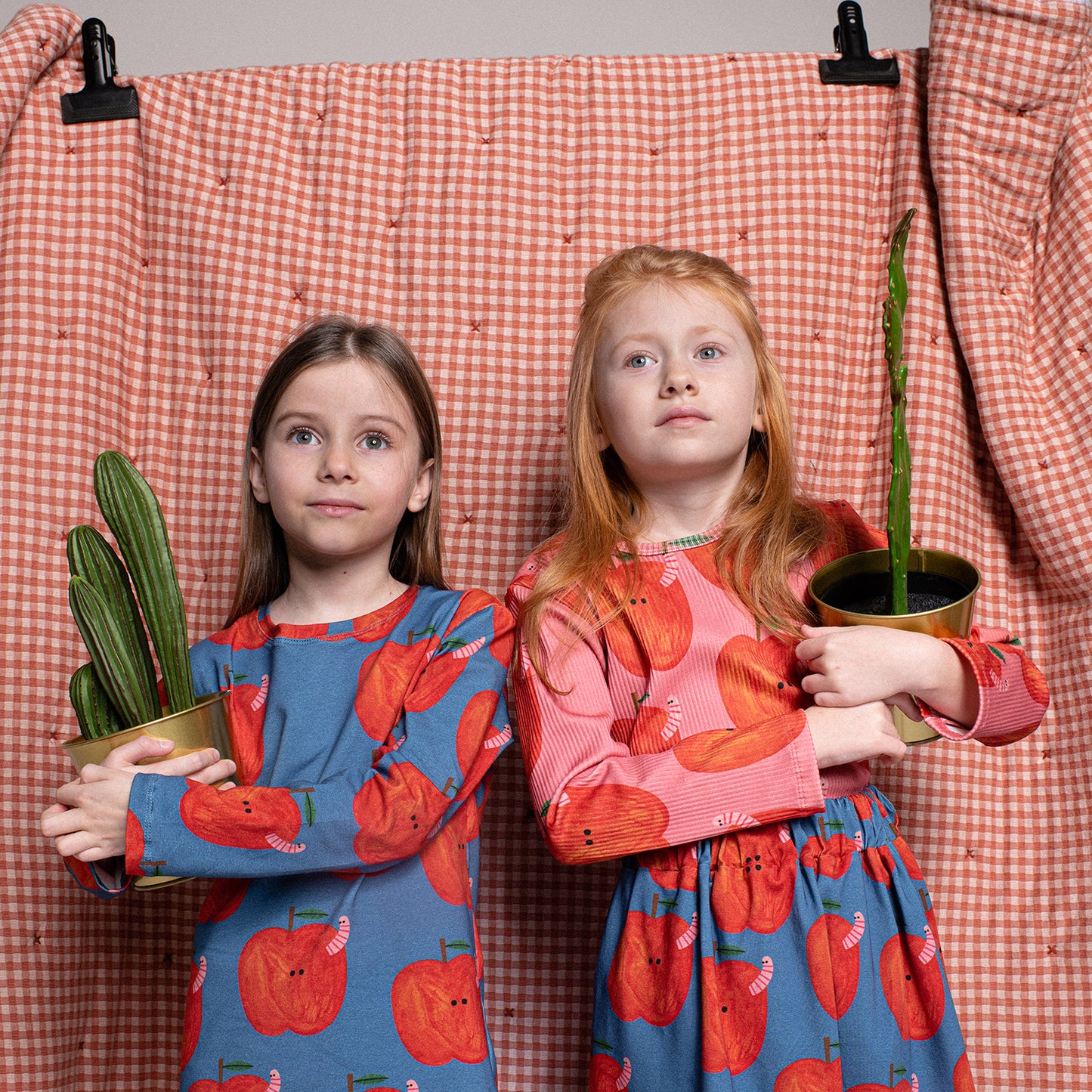 Girl wearing Don't Grow Up organic Ribbed long sleeve t-shirt- apples pink