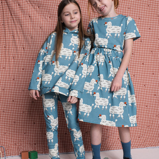 Girl wearing Don't Grow Up organic Leggings- dogs blue