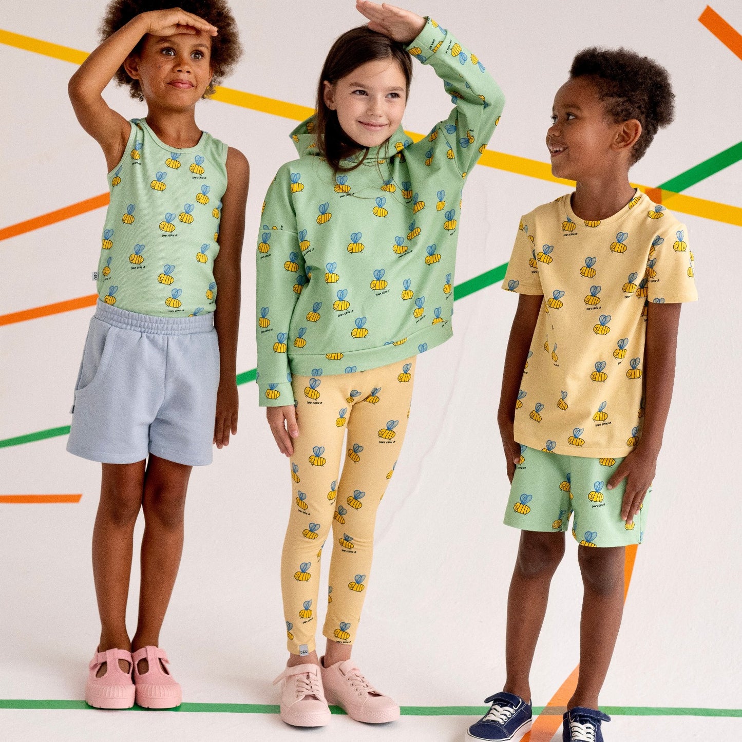 Boy wearing Don't Grow Up organic Shorts- green bee