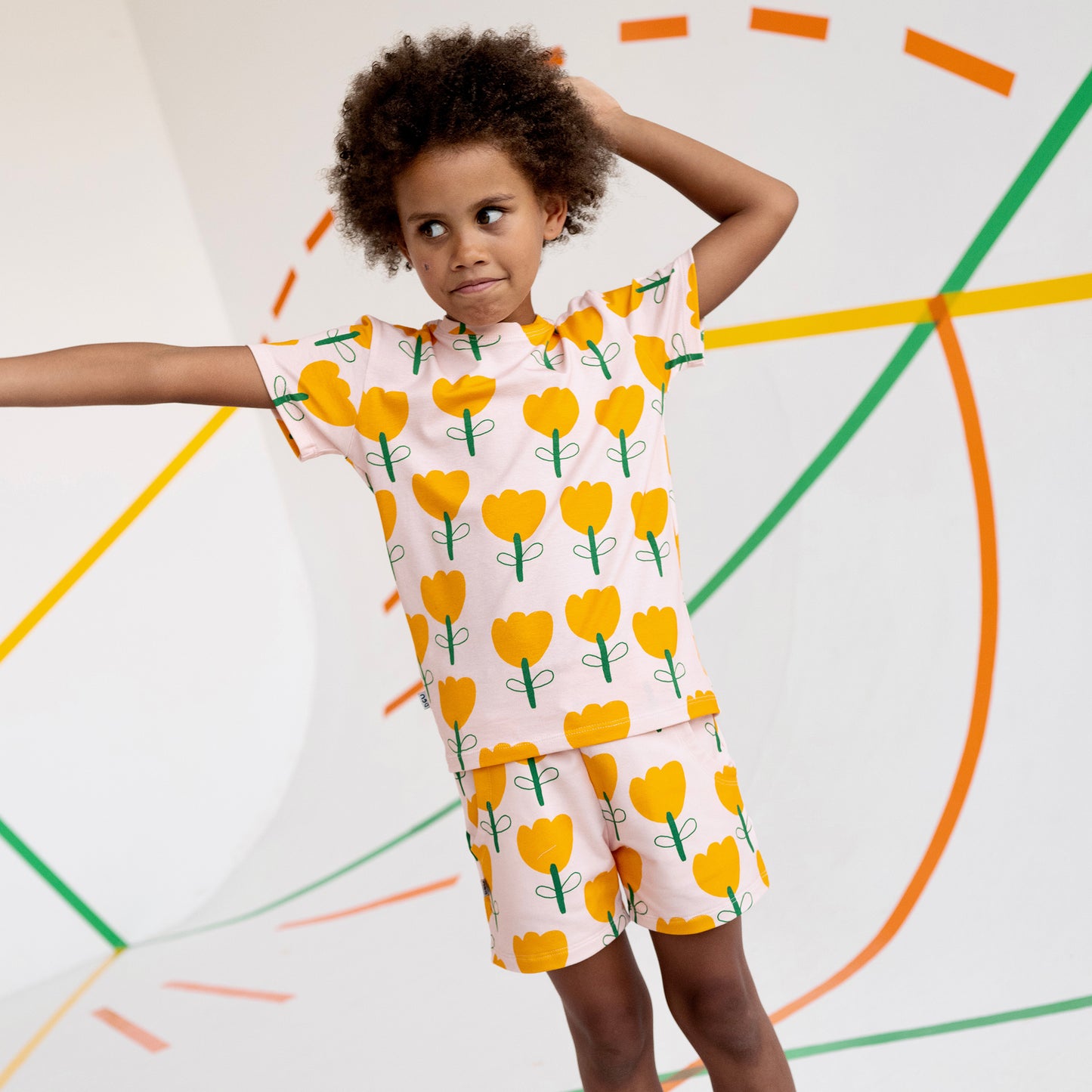 Girl wearing Don't Grow Up organic Shorts- yellow flower