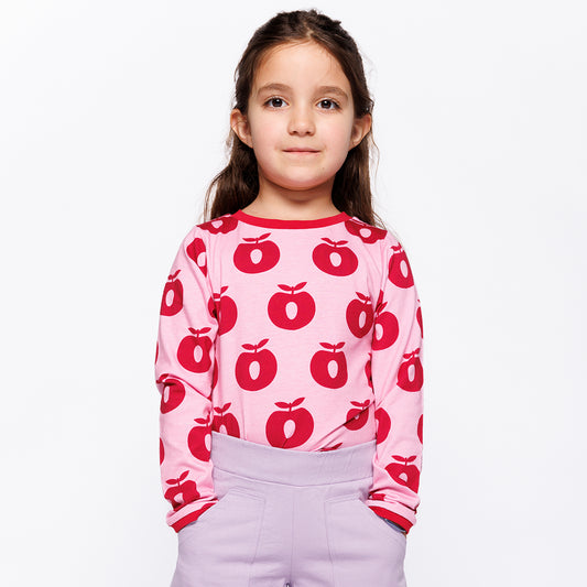 Girl wearing Småfolk Organic Long Sleeved Girls' T-shirt- Apples, Pink Lilac