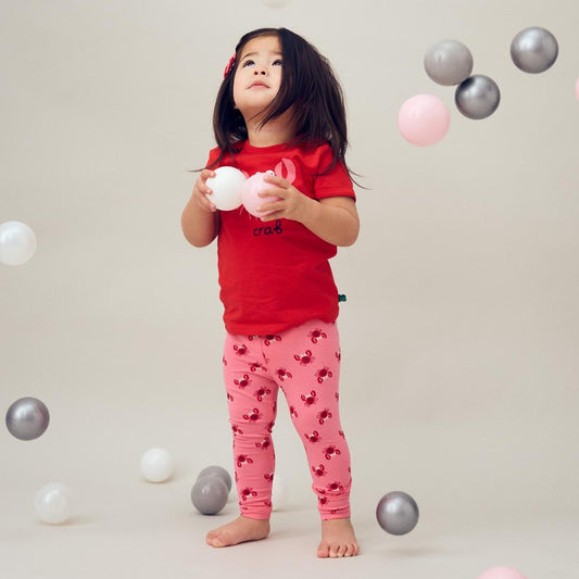 Girl wearing Fred's World organic Leggings- pink crab