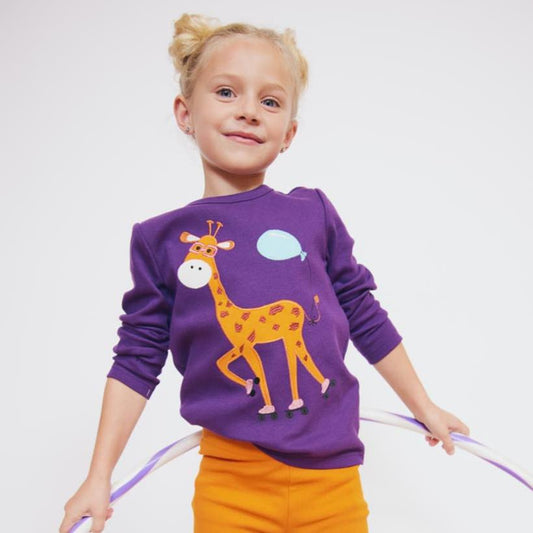 Girl wearing Fred's World organic Long sleeved top- giraffe appliqué