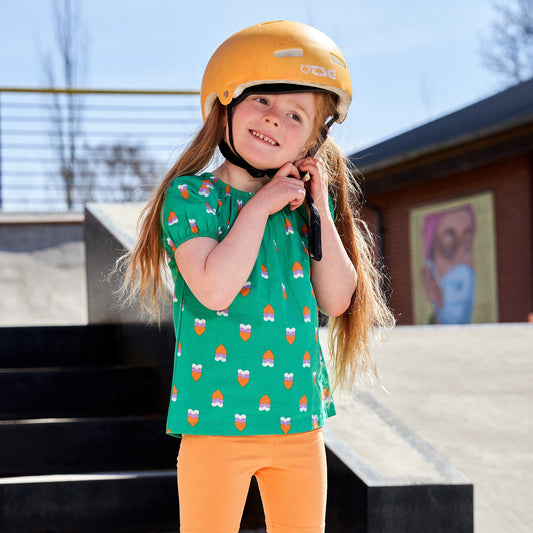 Girl wearing Fred's World organic Short sleeve top- heartbeat