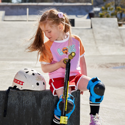 Girl wearing Fred's World organic Raglan t-shirt- love appliqué