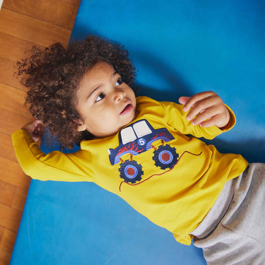 Boy wearing Fred's World Long sleeved top- monster truck appliqué