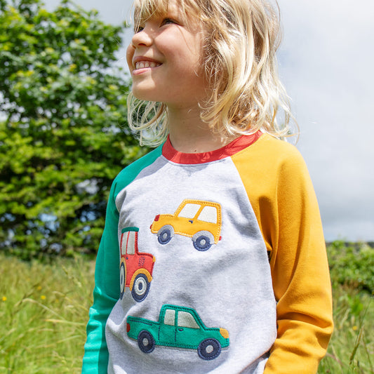 Boy wearing Frugi organic Raglan top- vehicles appliqué