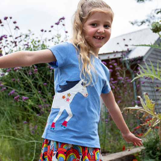 Girl wearing Frugi Organic Short-sleeved t-shirt- horse wraparound appliqué