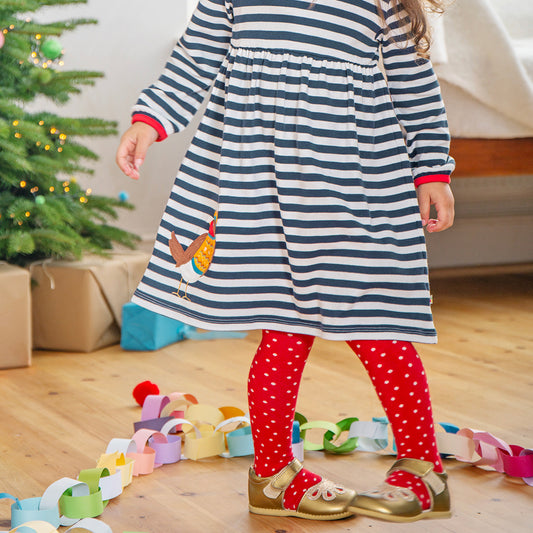 Girl wearing Frugi organic 2-pack tights- robins/red polka dot