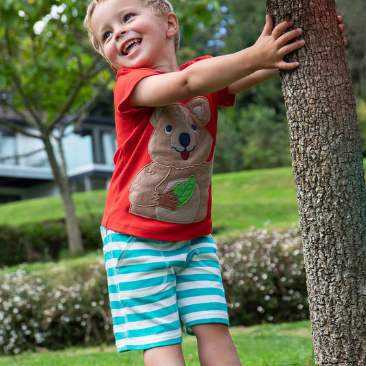 Boy wearing Frugi Organic Shorts- sea moss stripe