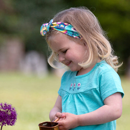 Girl wearing Kite organic Headband- patchwork planet