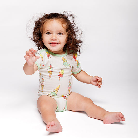 Baby wearing Smafolk organic Short sleeved bodysuit- ice cream, marshmallow