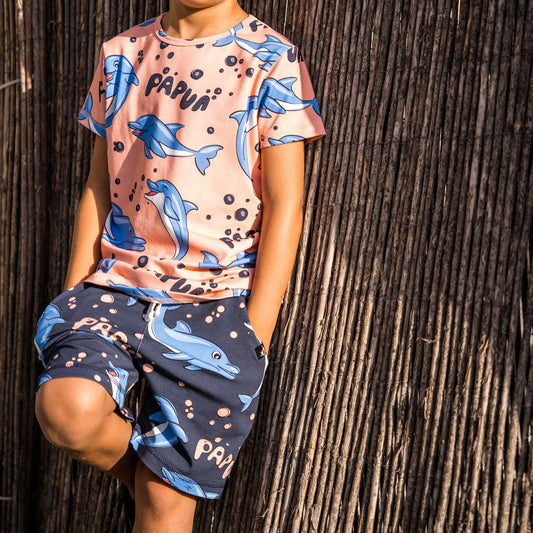 Boy wearing Mullido organic Shorts- dolphins, black