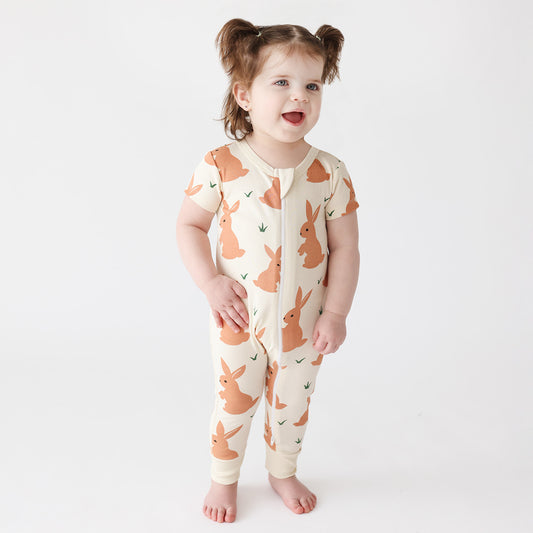 Baby wearing Parade Organics Zip romper- brown bunnies