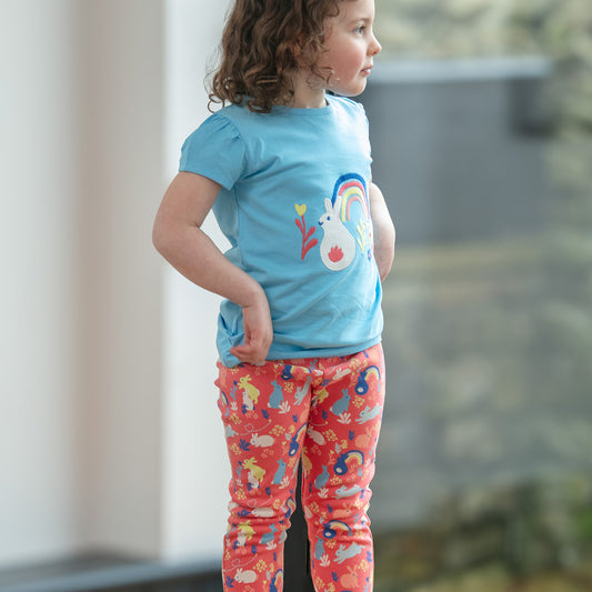 Girl wearing Piccalilly organic Short sleeve top- rainbow bunny appliqué