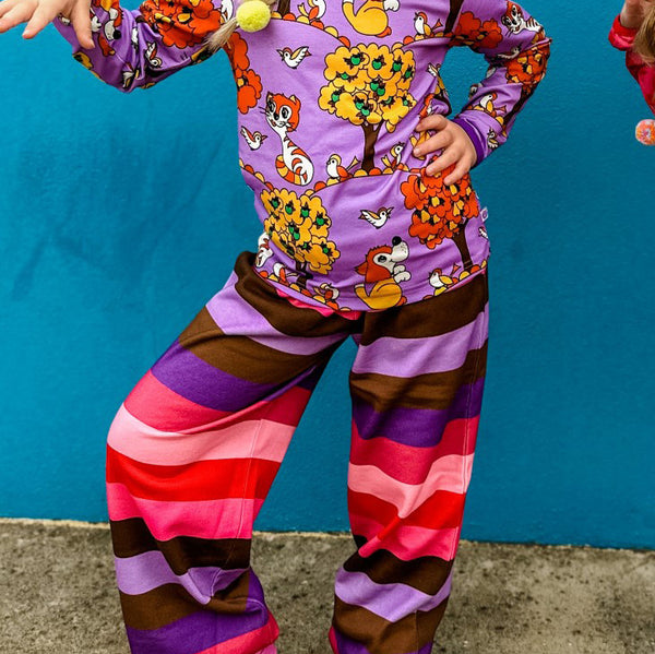 Girl wearing Smafolk organic Sweatpants- purple heart striped