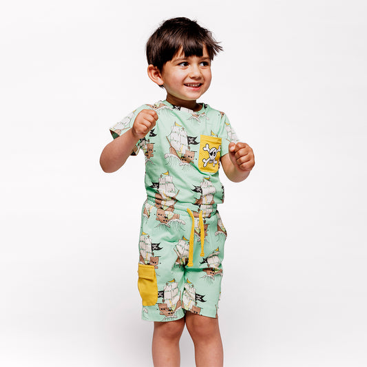 Boy wearing Smafolk organic Short sleeved t-shirt- pirate ships, minty green
