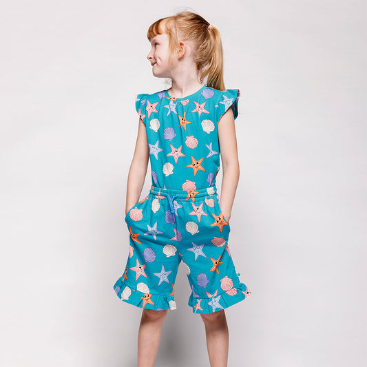 Girl wearing Smafolk organic Cap sleeved ruffle t-shirt- starfish, teal blue