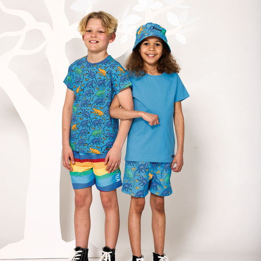 Boy wearing Villervalla recycled polyester Board shorts- ocean stripe