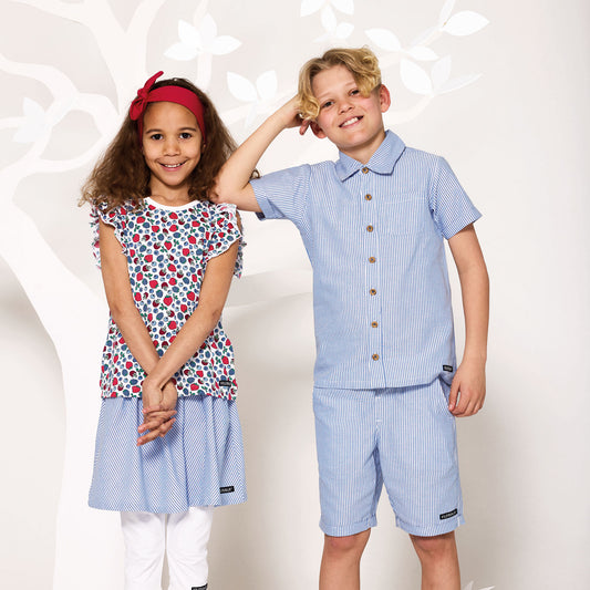 Girl wearing Villervalla organic Ruffle tank top- berry