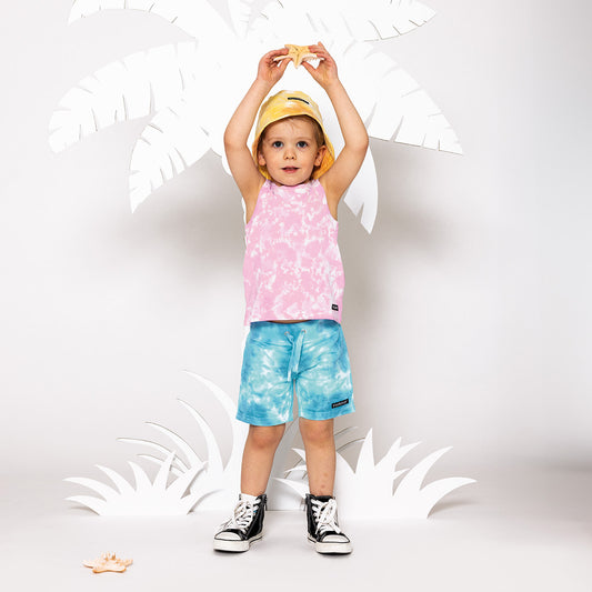 Boy wearing Villervalla organic Shorts- lake/pool tie dye
