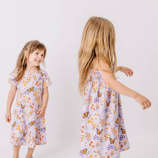 Girl wearing Walkiddy organic Short sleeve dress- flowers & butterflies