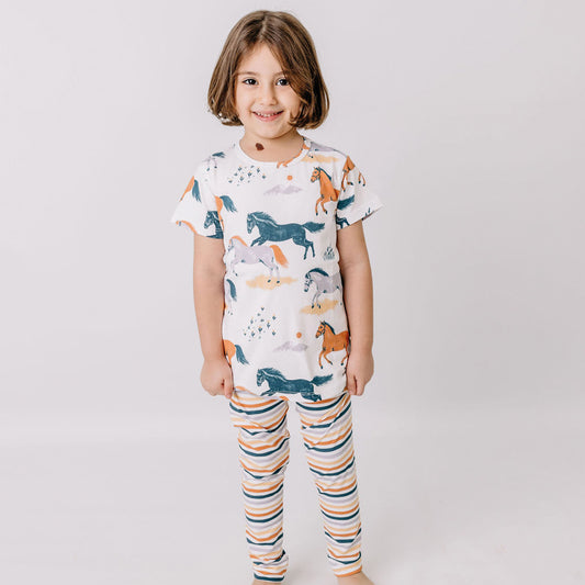 Girl wearing Walkiddy organic Leggings- colorful stripes