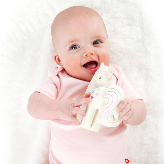 Baby with Tikiri Toys Natural rubber teether with crinkle tail- unicorn