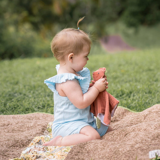 Baby with Tikiri Toys organic Lovey with teether- lion