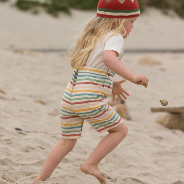 Girl wearing Little Green Radicals organic Rainbow Striped Overall Shorts