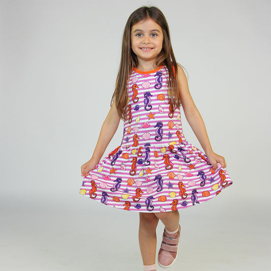 Girl wearing Smafolk organic Sleeveless dress- seahorses, spring pink