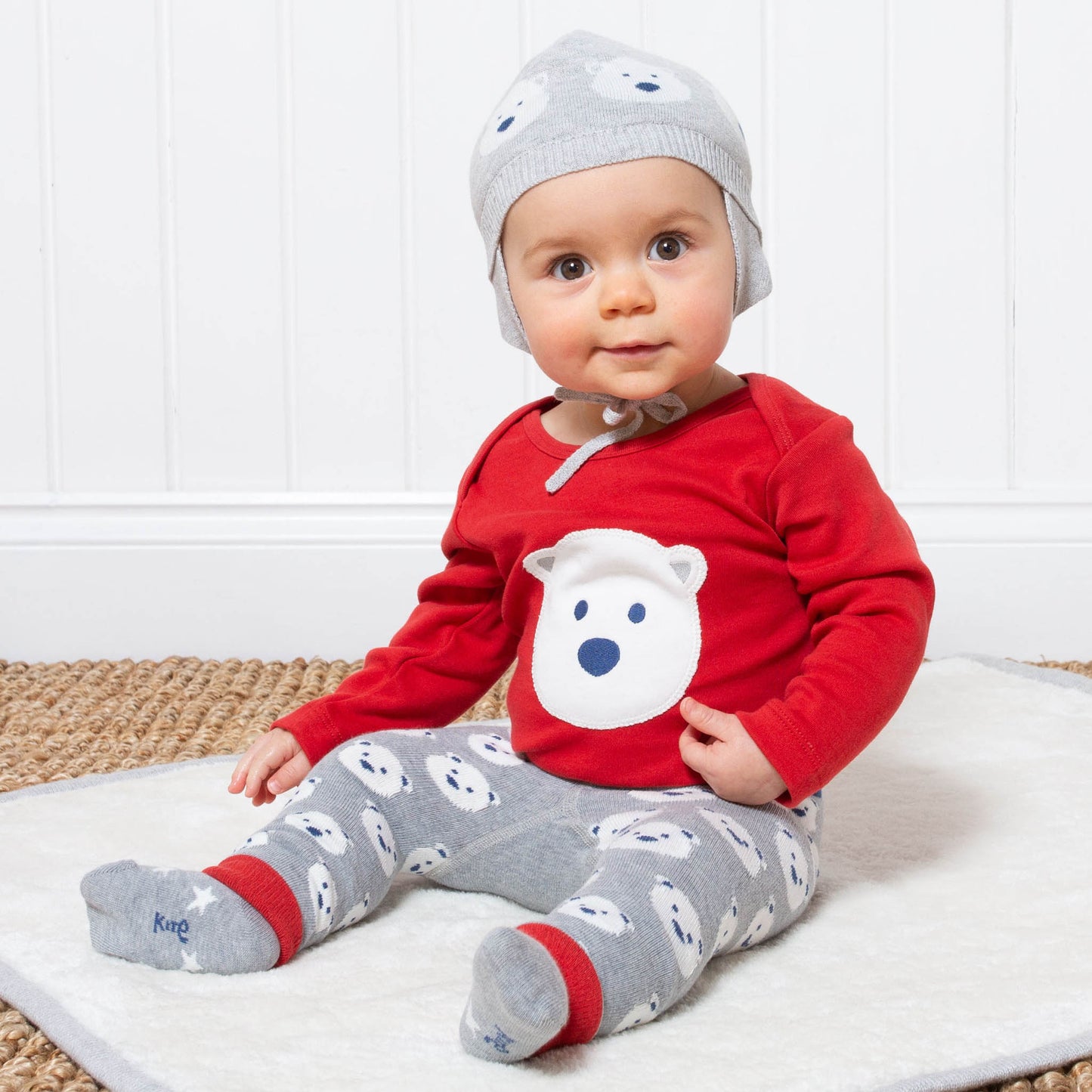 Baby wearing Kite's red snow bear bodysuit