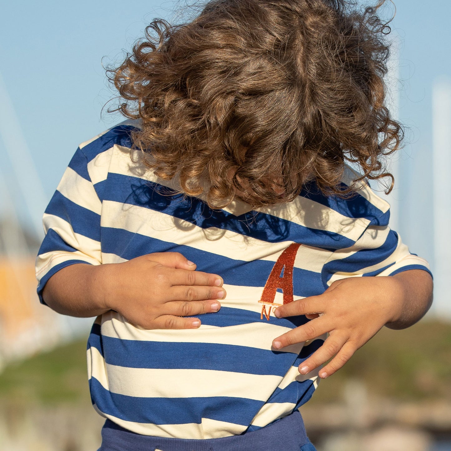 Boy wearing Alba of Denmark Surfing around t-shirt- true blue stripes