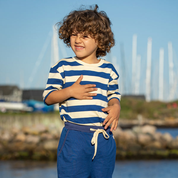 Boy wearing Alba of Denmark Surfing around t-shirt- true blue stripes