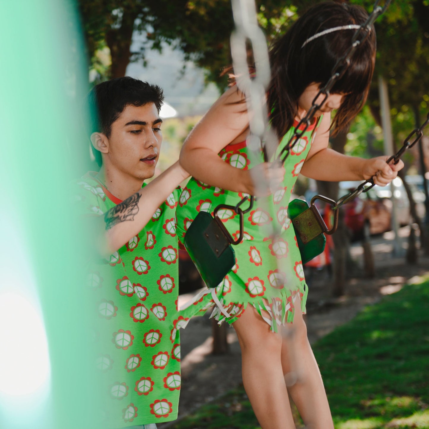 Girl wearing Moromini organic Tank dress with fringe- peace flower