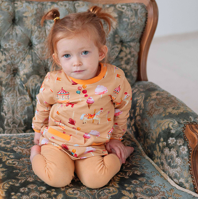 Girl wearing Curious Stories organic Long sleeve tunic- fun fair