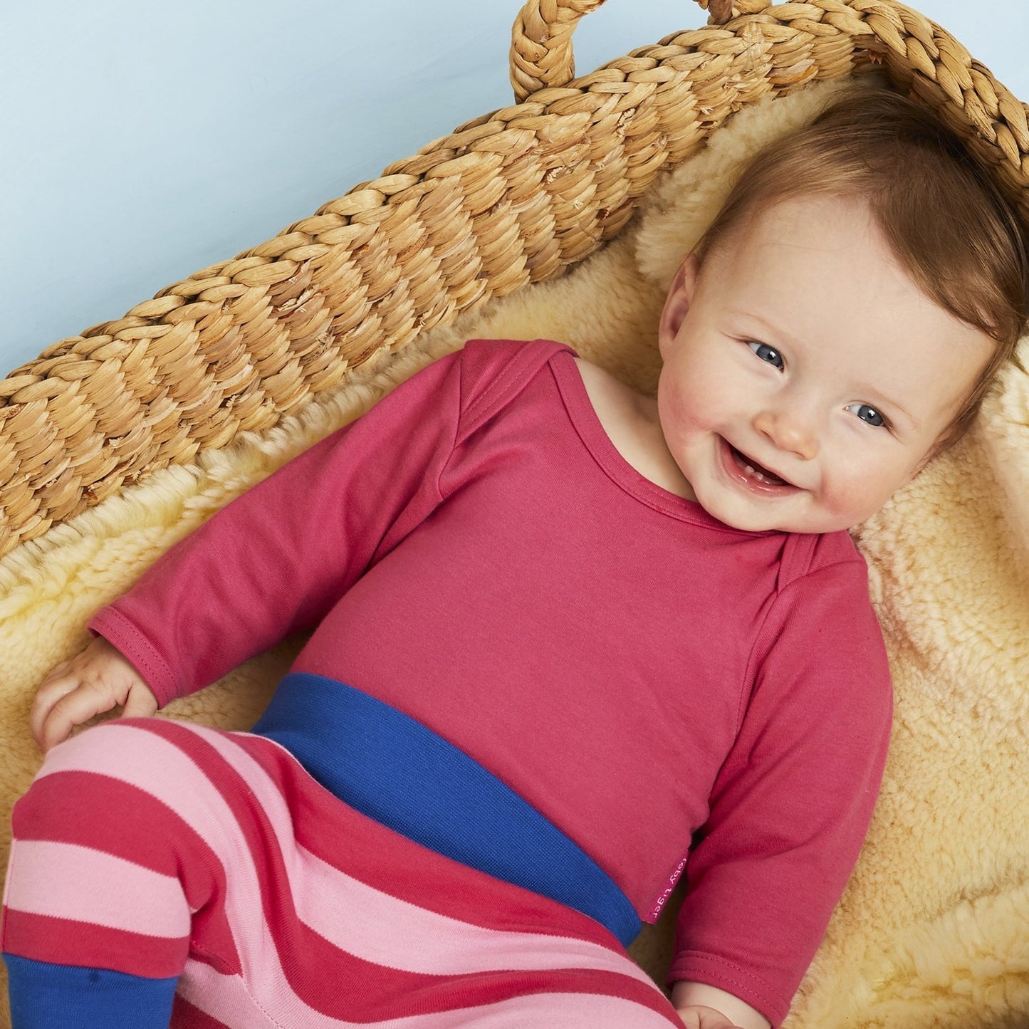 Baby wearing Toby Tiger basic pink long sleeve bodysuit