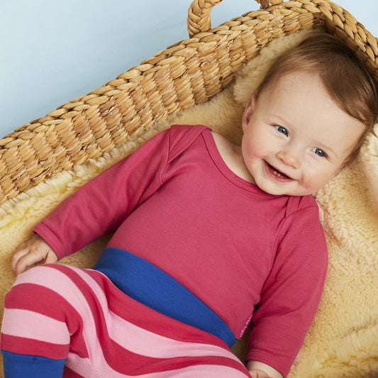 Baby wearing Toby Tiger basic pink long sleeve bodysuit