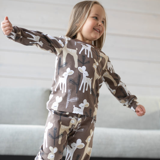 Girl wearing PaaPii Rusko pajamas- choco/latte bambi