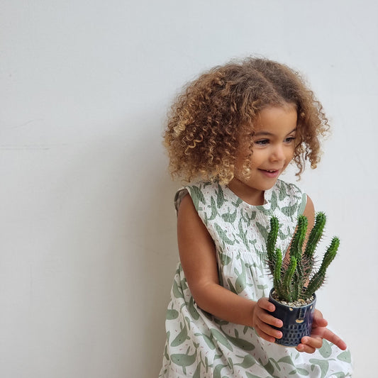 Girl wearing Pigeon Organics Sleeveless smock dress- tea green whales