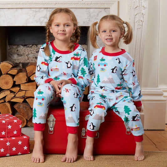 Girls wearing Toby Tiger Penguin's Christmas print pajamas