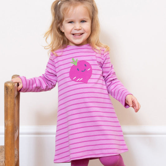 Girl wearing Kite organic Baby beet dress