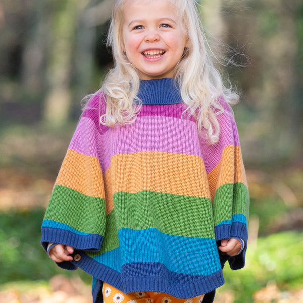 Girl wearing Kite Clothing Organic Rainbow poncho